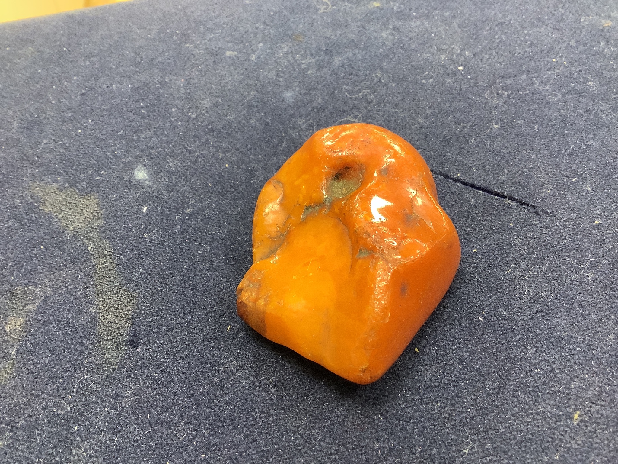 A string of amber beads and a specimen piece of Baltic amber